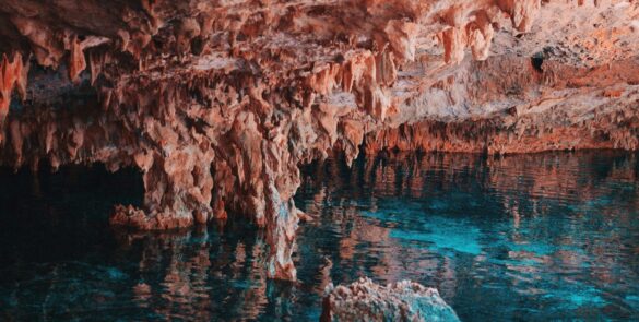 Explore the breathtaking limestone formations and clear waters in a Mexican cave.